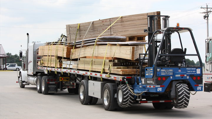 Delivery truck loaded with bundled building kit materials